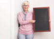 Woman Holding Chalkboard To Teach Youth