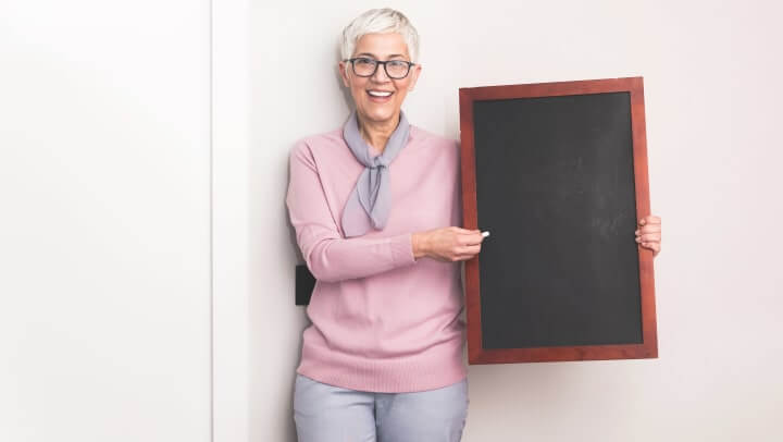 Teaching_ytbuxh Woman Holding Chalkboard To Teach Youth