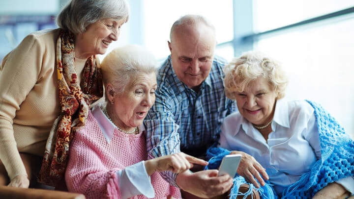 Senior Living Residents Looking At Smartphone