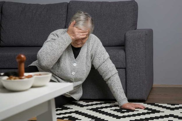 Senior woman lying on the floor in living room. Woman fell on the floor because of heart attack Senior woman lying on the floor in living room. Woman fell on the floor because of heart attack