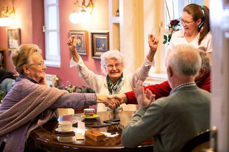 Retirement home occupants sitting at the table together