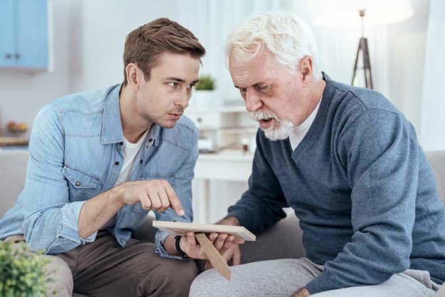 Unfamiliar person. Concerned senior man asking questions and man showing photo