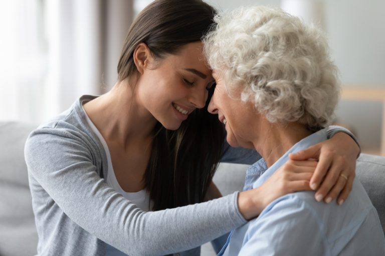 Grownup granddaughter touch foreheads hugs elderly grandmother enjoy tender moment 6 Ways To Help Seniors With Sundown Syndrome