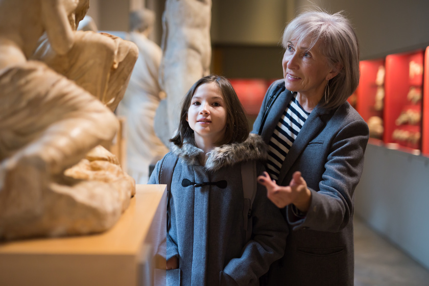 Elderly female tutor showing tween girl ancient sculptures in museum Five Health Benefits Of Visiting Museums For The Elderly