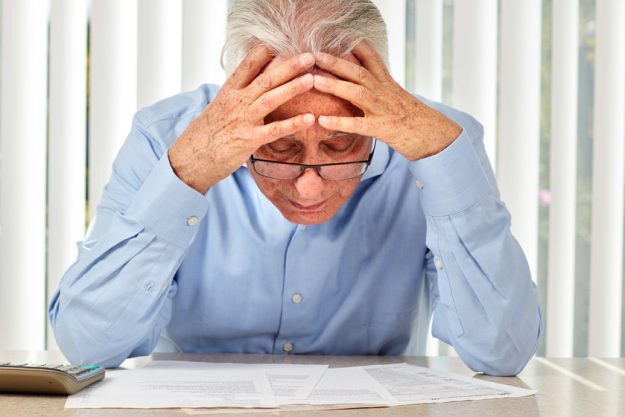 Elderly man with papers. X Types Of Anxiety Disorder That Might Affect Your Aging Parent