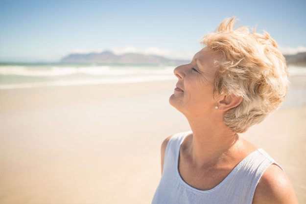 Close up of smiling senior woman with eyes closed Close up of smiling senior woman with eyes closed