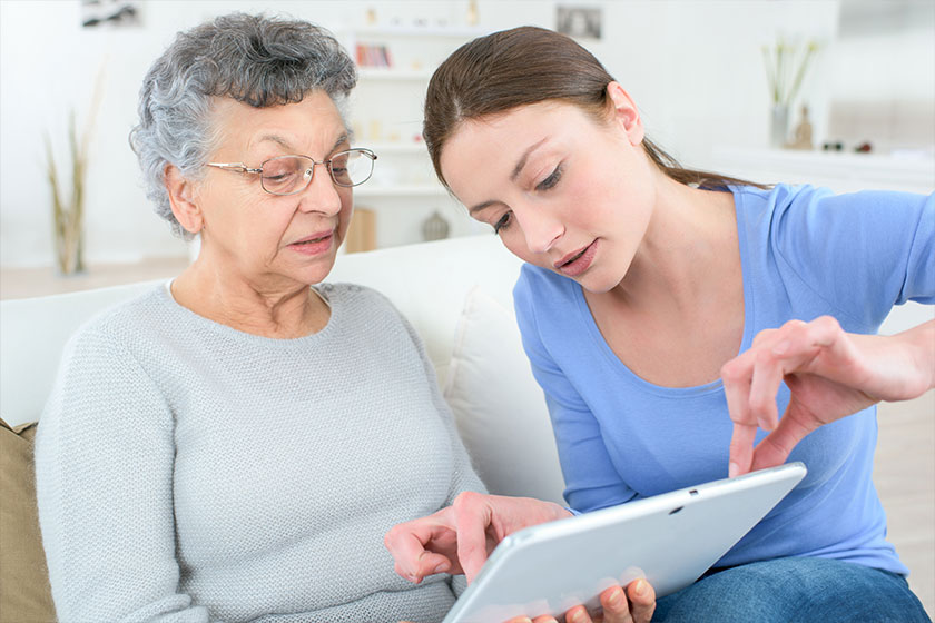 teenage granddaughter showing grandmother how to use digital tablet teenage granddaughter showing grandmother how to use digital tablet