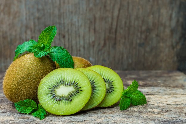 Close up fresh kiwi fruit on old wood background