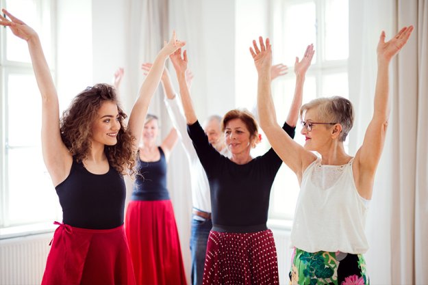 Group of senior people in dancing class with dance teacher