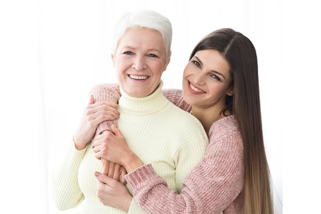 Happy mother and daughter hugging and looking at camera Happy mother and daughter hugging and looking at camera