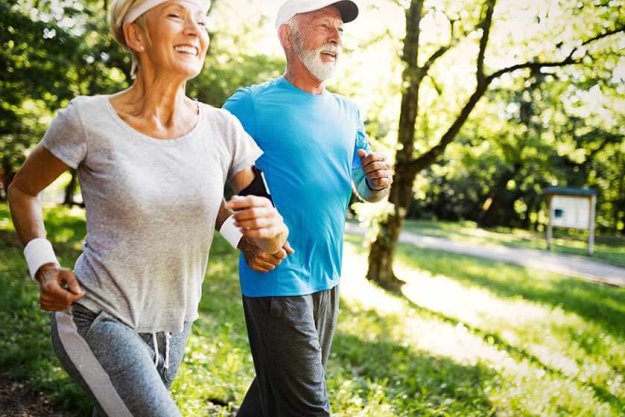 Mature couple jogging and running outdoors in city