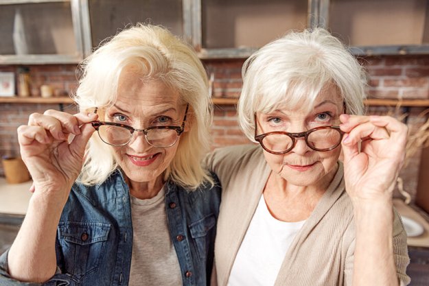 Mature female friends observing something interesting Mature female friends observing something interesting