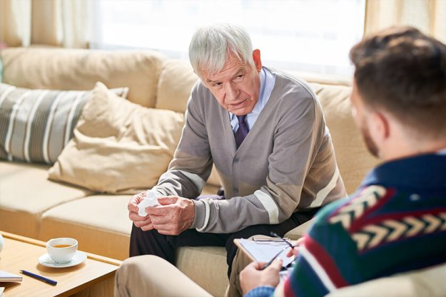 Portrait of senior man holding tissues sharing mental problems Portrait of senior man holding tissues sharing mental problems