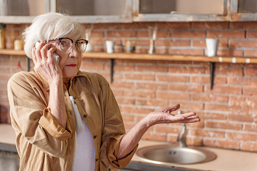 Puzzled senior lady talking on mobile phone Puzzled senior lady talking on mobile phone