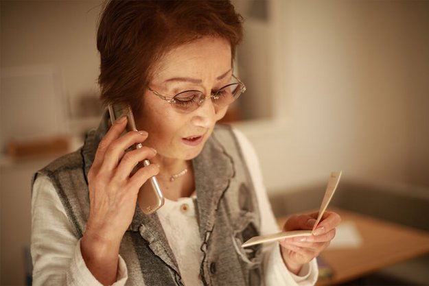 senior-woman-talking-with-a-passbook senior-woman-talking-with-a-passbook