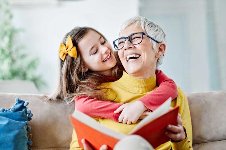 grandchild granddaughter grandma grandmother reading book girl senior