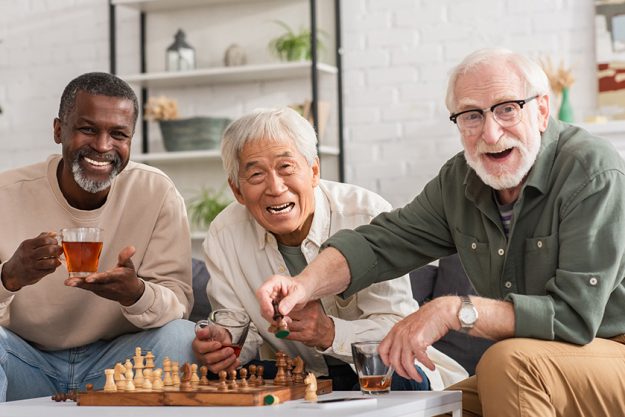 Cheerful multiethnic elderly friends looking at camera Cheerful multiethnic elderly friends looking at camera
