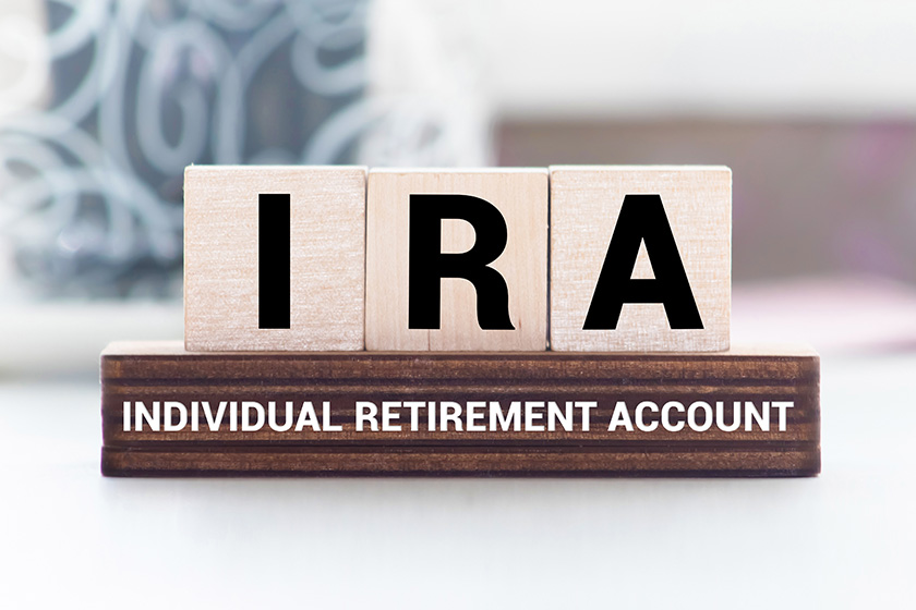 IRA individual retirement account word on wood cube block IRA individual retirement account word on wood cube block
