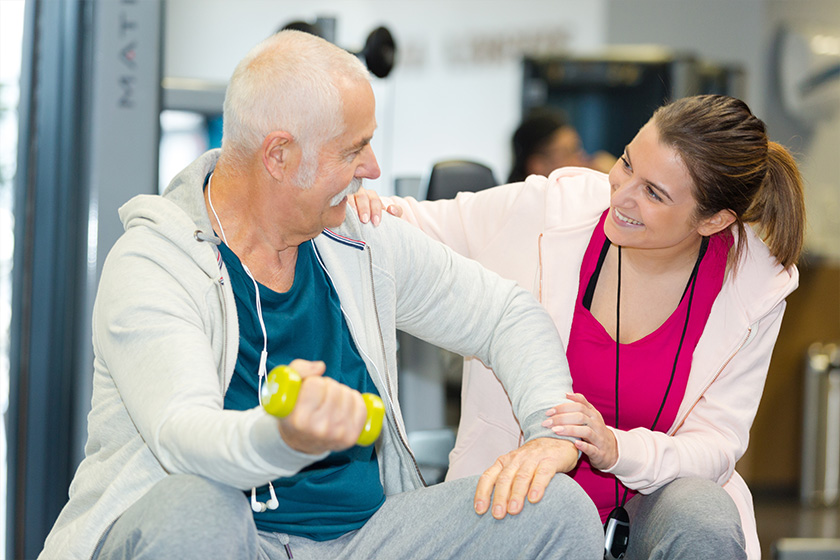 senior man and his coach smiling senior man and his coach smiling
