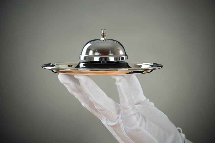 Cropped Hand Of Waiter Holding Service Bell In Tray 8 Concierge Services To Expect In Senior Living Communities In Gary, IN