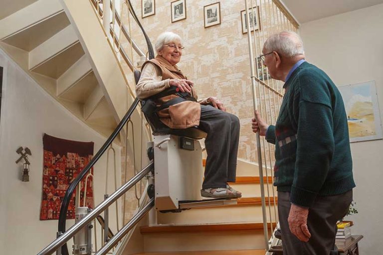 elderly couple at the stairlift elderly couple at the stairlift