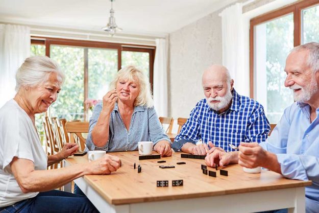 Group of seniors playing dominoes