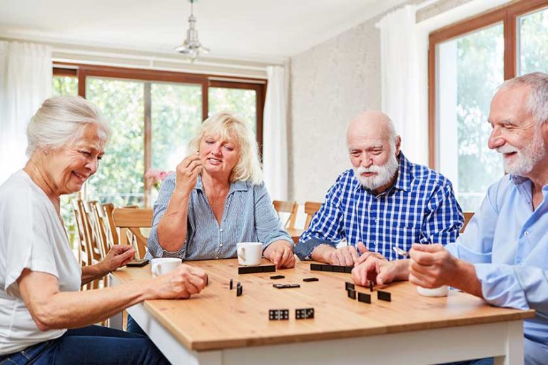 Group of seniors playing dominoes
