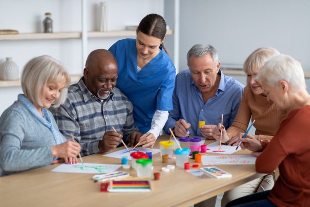 Creative senior men and women doing arts and crafts together Learn About The Value Of Senior Communities In Gary, IN
