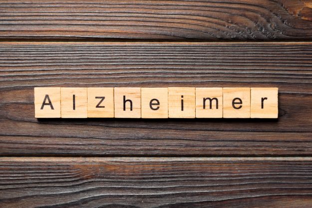 Alzheimer word written on wood block. Alzheimer text on wooden table for your desing, concept Learn The Signs Of Alzheimer's Disease In Your Loved One