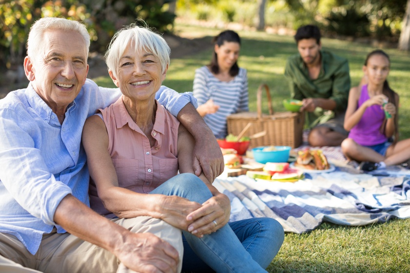 Portrait of happy senior couple sitting in the park Portrait of happy senior couple sitting in the park