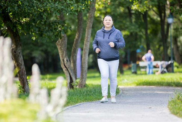Mature woman jogging in the park. Healthy lifestyle Mature woman jogging in the park. Healthy lifestyle
