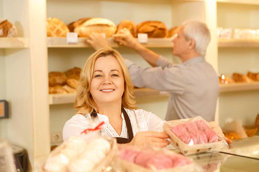 Senior couple running their small family business working at the bakery