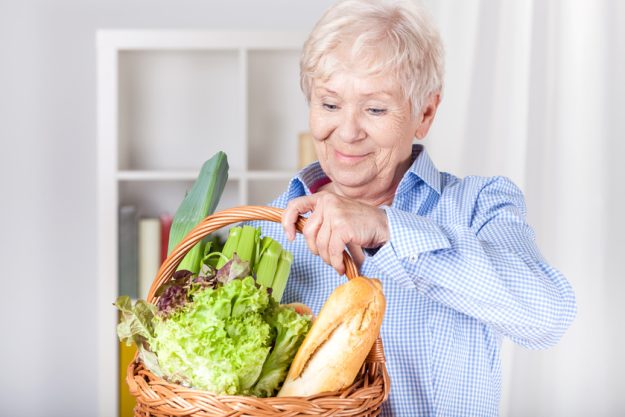 Elderly woman with shopping basket The Surprising Benefits Of Going Shopping For Your Age