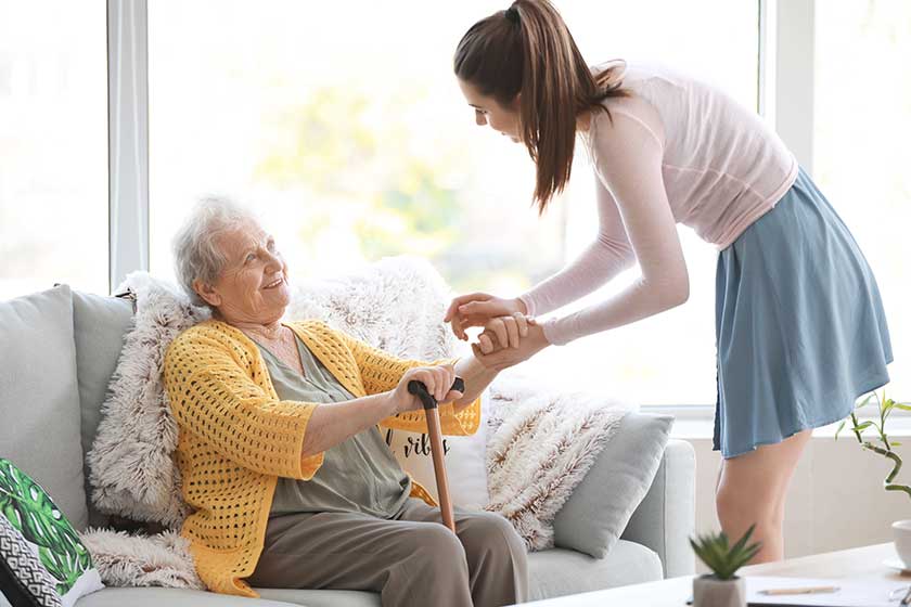 Caregiver with senior woman in nursing home