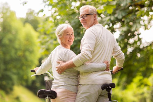 happy senior couple with bicycles at summer park Retire In Zionsville, IN: 4 Things You Need To Know
