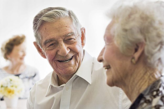Elderly Couple Talking in Nursing Home Elderly Couple Talking in Nursing Home