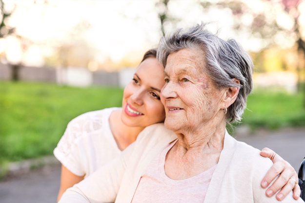 Elderly grandmother and granddaughter hugging