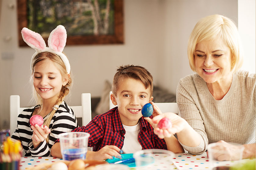 Happy easter! family, grandmother and children paint eggs for holiday Happy easter! family, grandmother and children paint eggs for holiday