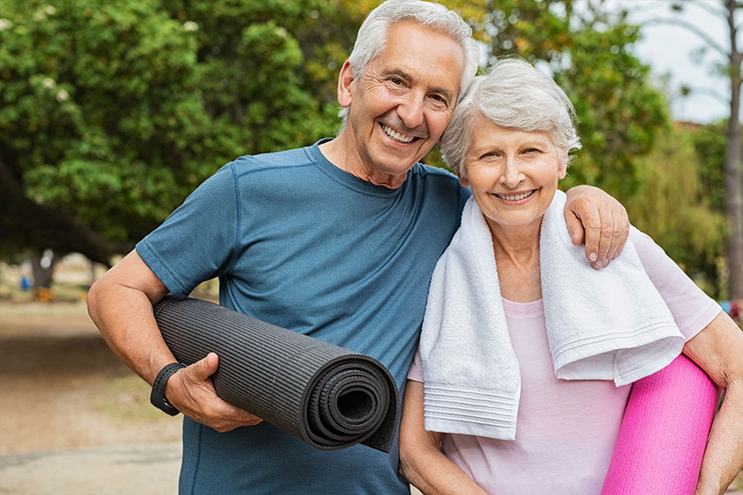 Happy senior couple with yoga mat Happy senior couple with yoga mat