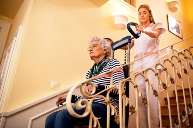 Nurse using machine for climbing to the stairs Nurse using machine for climbing to the stairs