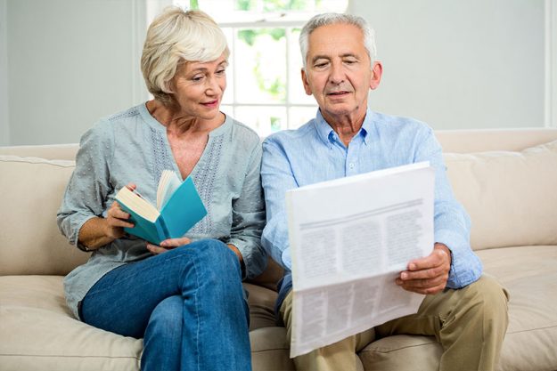Senior couple reading newspaper