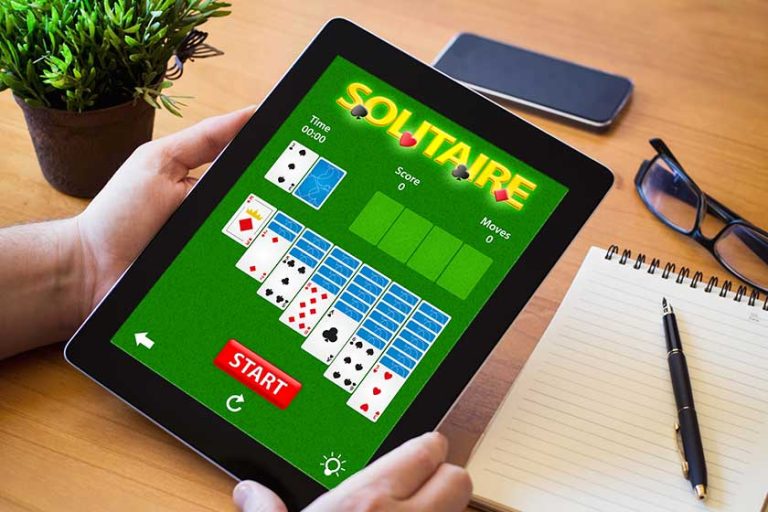 Man playing solitaire app on tablet