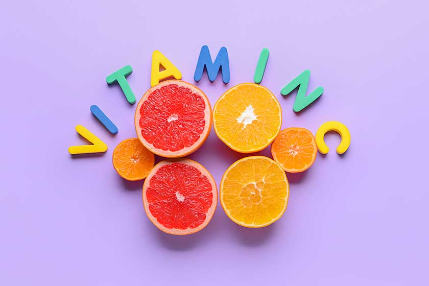 Text VITAMIN C and citrus fruits on color background Text VITAMIN C and citrus fruits on color background