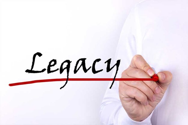 A person writes text, a word, the phrase Legacy with marker on a light background A person writes text, a word, the phrase Legacy with marker on a light background