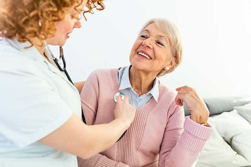 Health visitor and a senior woman during home visit