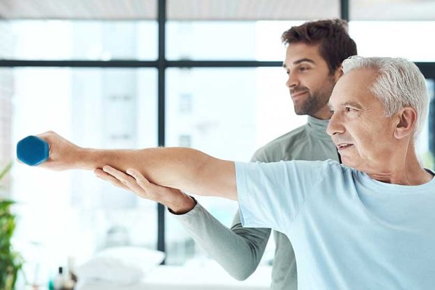 Helping his patient to stay fit Helping his patient to stay fit