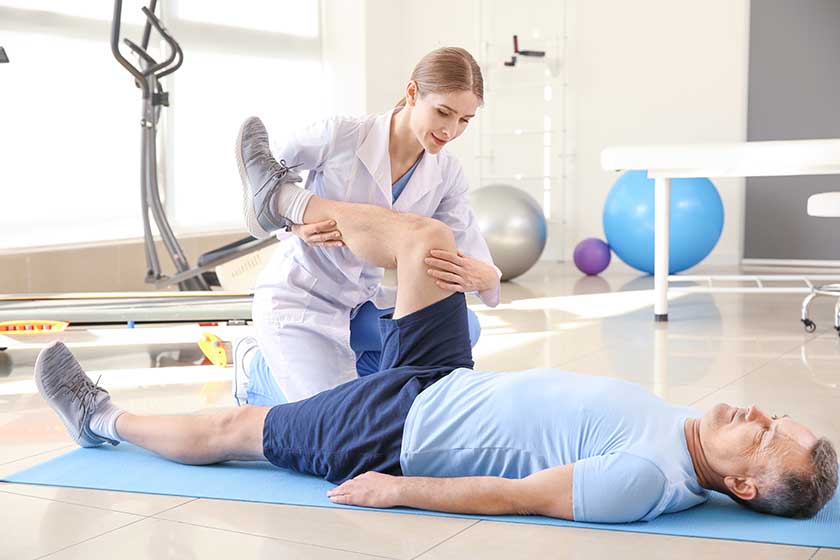 Physiotherapist working with mature patient