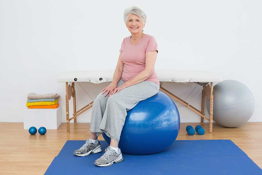 Portrait of a senior woman sitting on fitness ball Portrait of a senior woman sitting on fitness ball