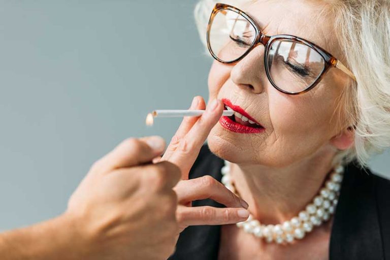 senior woman smoking cigarette