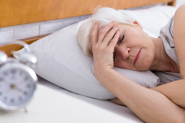 SEnior woman suffering from insomnia in bed